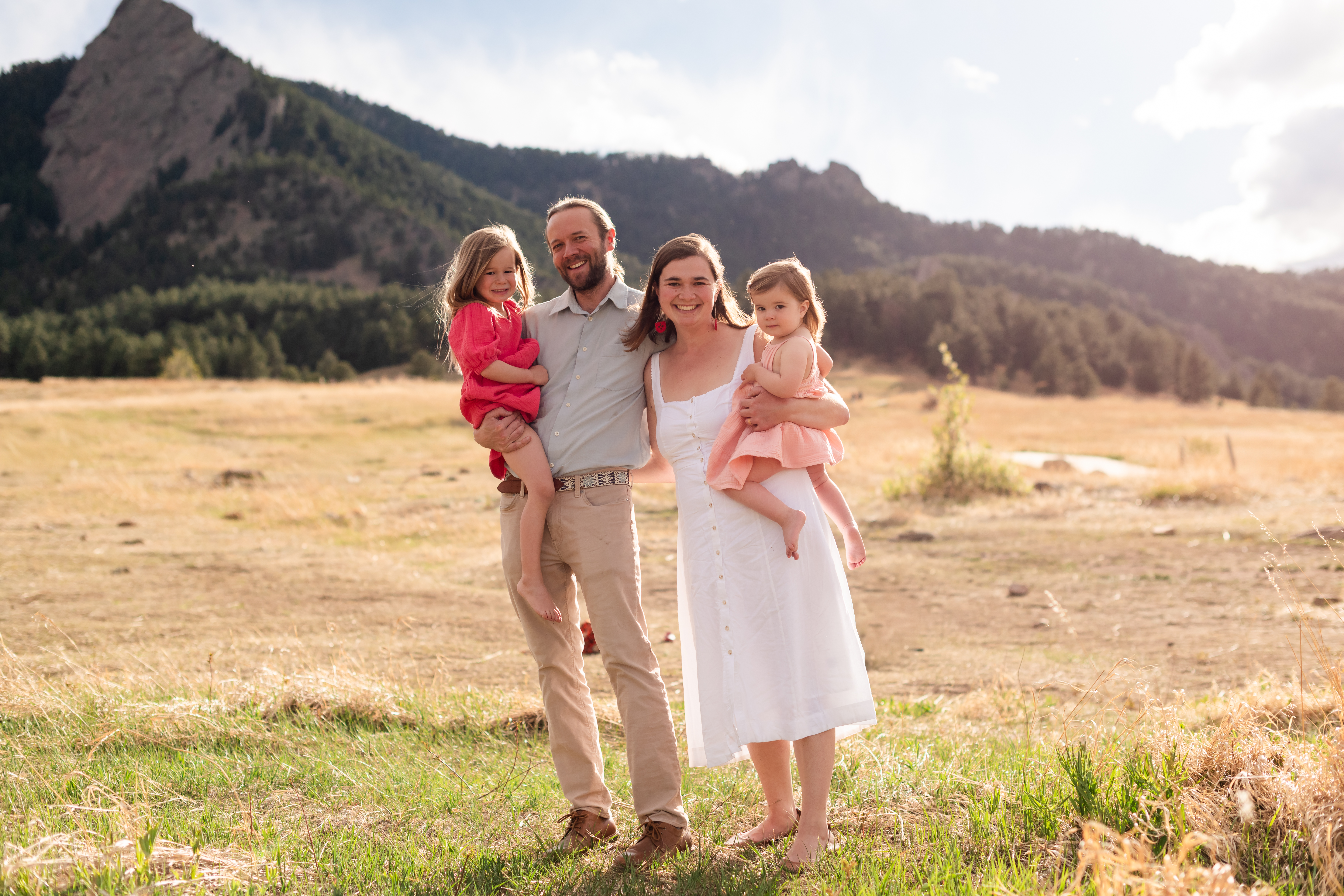 Will Evans with his wife and two daughters at Chautauqua Park in Boulder, Colorado, with the Flatiron mountains in the background.